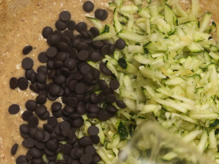 Fold-in-shredded-zucchini-and-chocolate-chips-gently,-without-overmixing