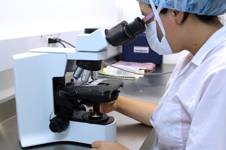 A person using a microscope in a laboratory setting, representing the scientific research behind new non-invasive endometriosis diagnostic tests