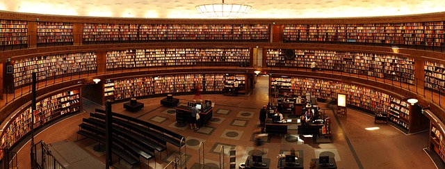 A grand library interior filled with rows of bookshelves, representing the habit of deep reading for brain health and cognitive focus.
