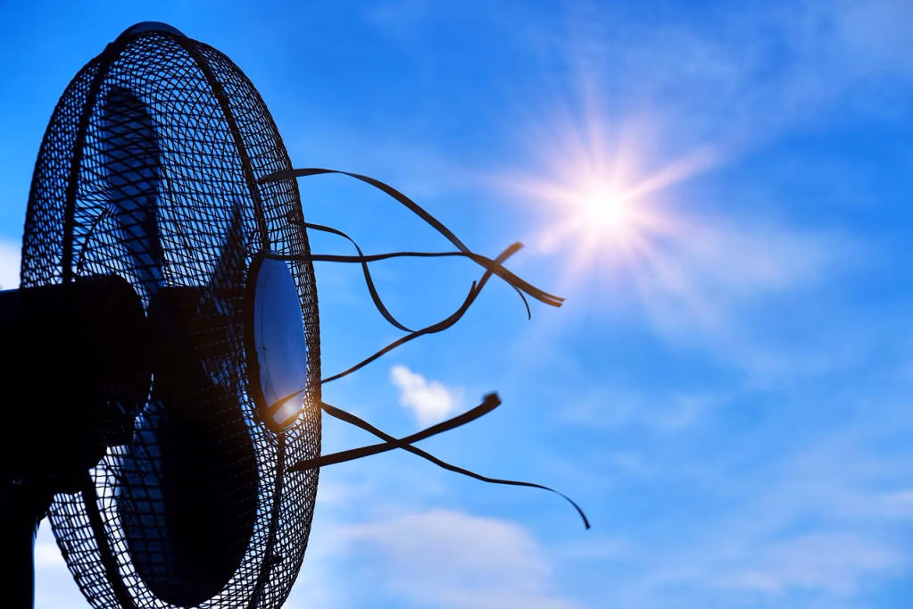 A conceptual image showing a sun and a fan representing overheating and cooling solutions for women experiencing hot flashes, night sweats, and temperature regulation issues