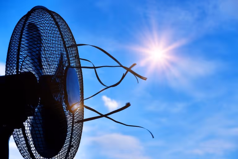 A conceptual image showing a sun and a fan representing overheating and cooling solutions for women experiencing hot flashes, night sweats, and temperature regulation issues
