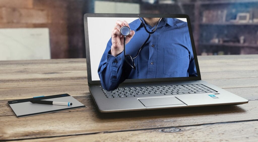 A doctor on a laptop screen holding a stethoscope, representing GLP-1 telehealth consultations and online medical prescribing for weight loss medications