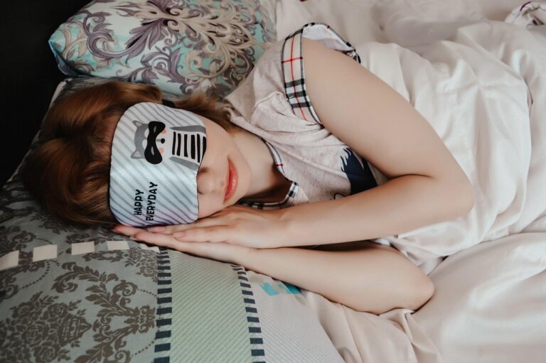Woman sleeping peacefully wearing a silk sleep mask, representing deep sleep quality and its benefits for heart health and cardiovascular wellness