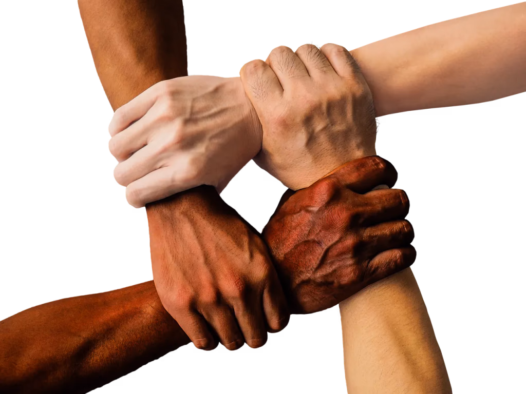 Group of diverse hands stacked together showing teamwork, friendship, and social connection for stress relief - representing the 5-minute connection habit for lowering stress