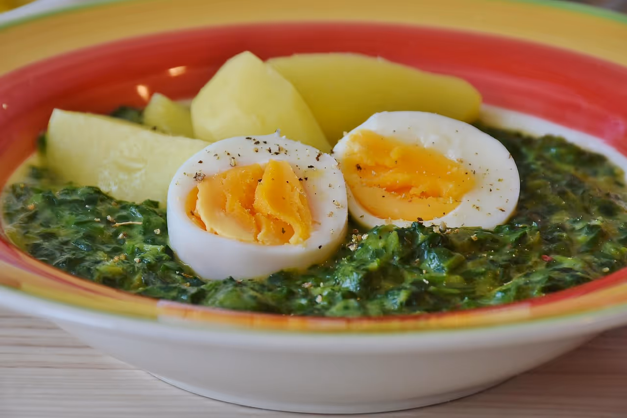 A delicious high-protein meal prep dish featuring eggs, spinach, and roasted potatoes on a plate, showcasing a healthy make-ahead meal option for busy weekdays.