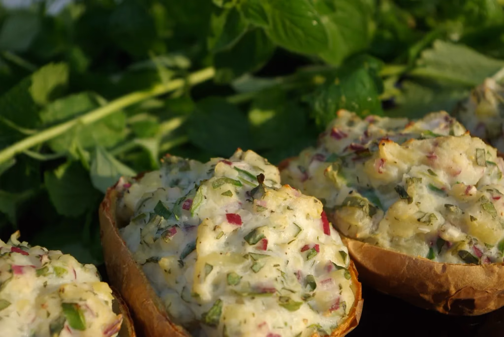 Stuffed baked potato with fillings on a plate, a healthy cholesterol-lowering lunch option rich in fiber