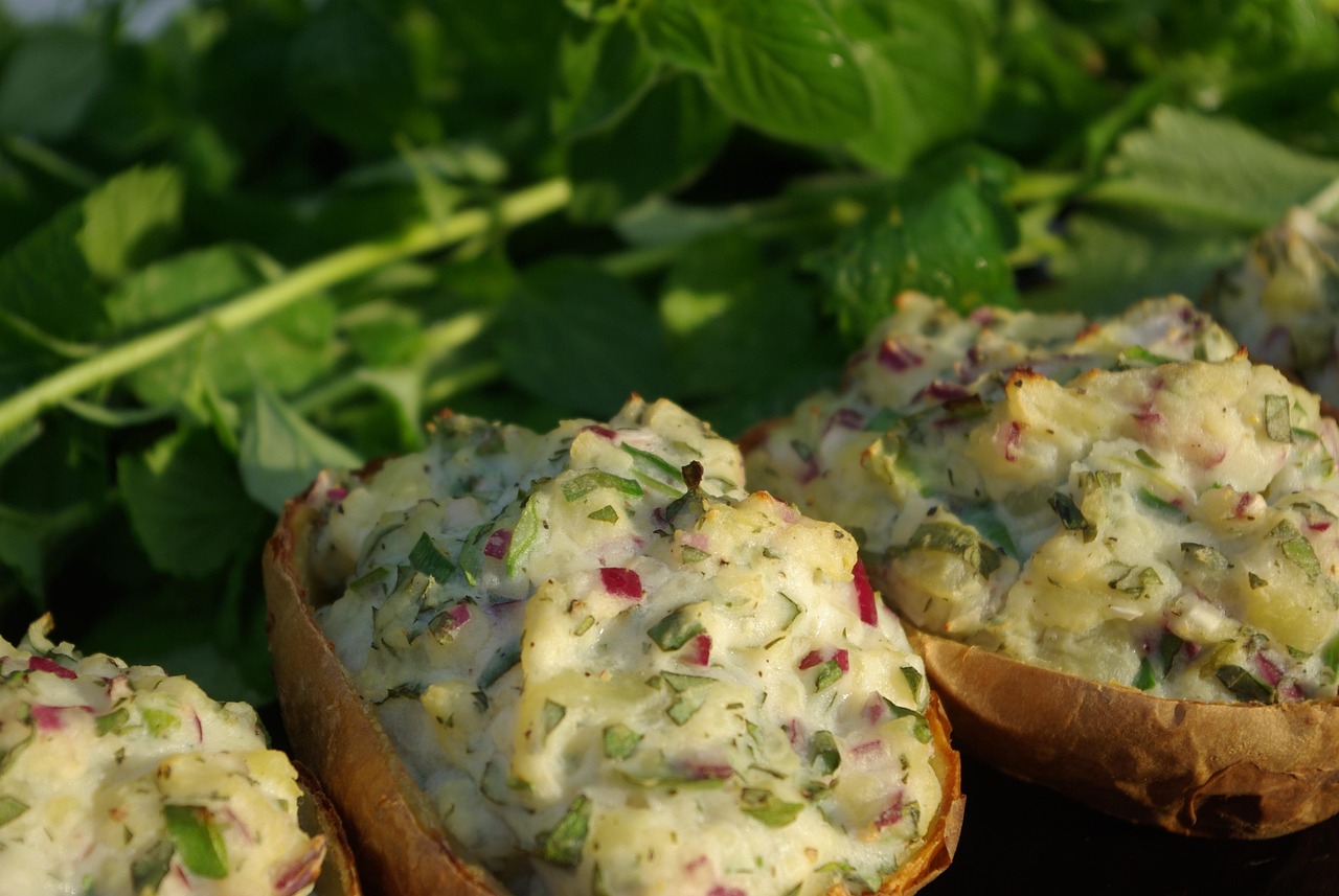 Stuffed baked potato with fillings on a plate, a healthy cholesterol-lowering lunch option rich in fiber