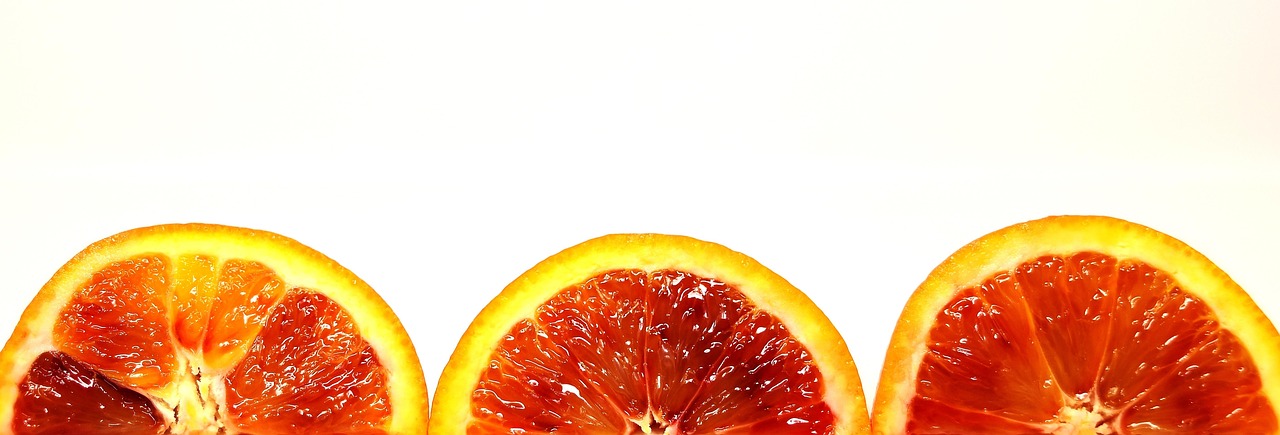Fresh blood oranges on a dark surface - citrus fruits rich in potassium and antioxidants, part of a heart-healthy diet for supporting healthy blood pressure levels