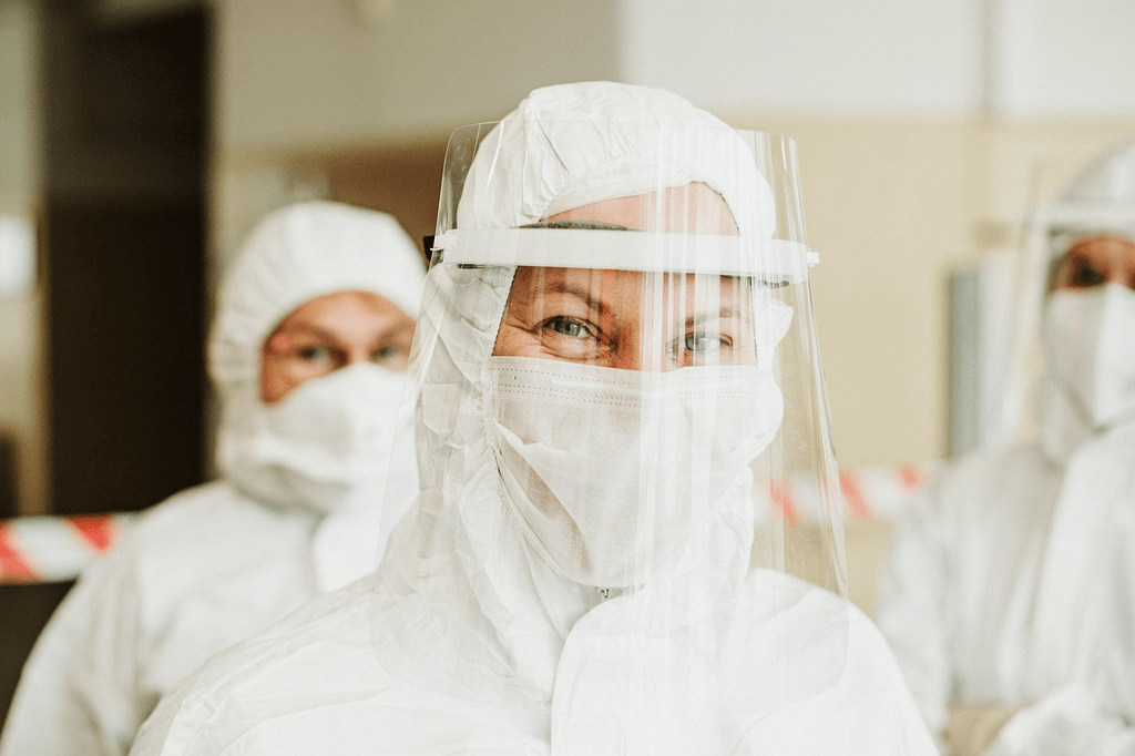 Healthcare professional wearing face mask and face shield, representing hospital infection prevention and patient safety measures