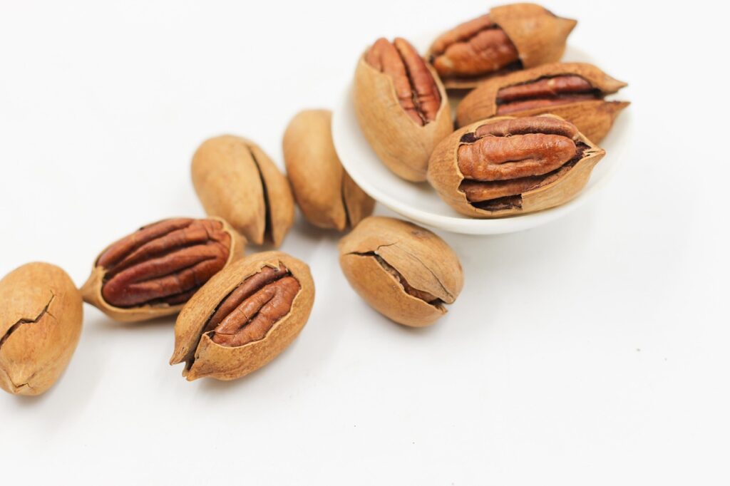 A bowl of pecans and nuts, representing affordable anti-inflammatory snack options for managing psoriasis symptoms on a budget