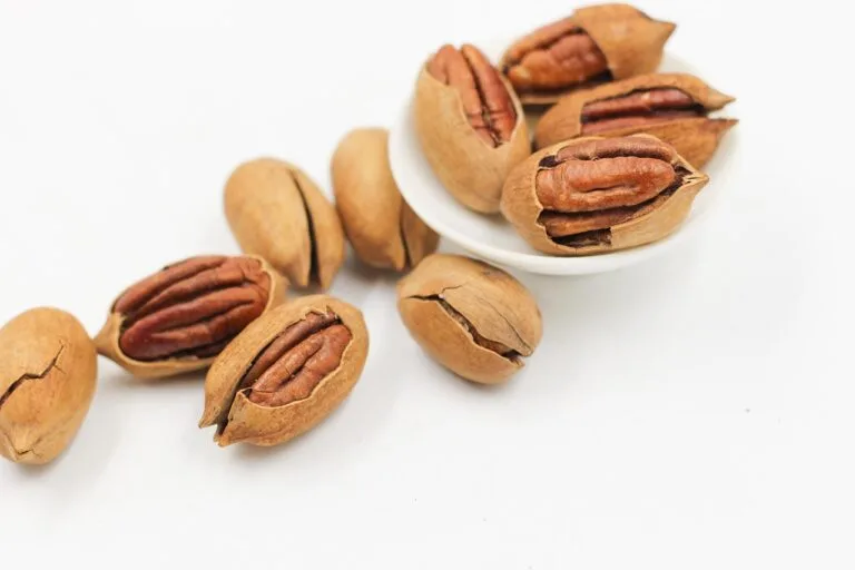 A bowl of pecans and nuts, representing affordable anti-inflammatory snack options for managing psoriasis symptoms on a budget