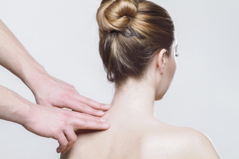 Woman receiving a professional shoulder massage therapy session, representing the importance of paying attention to persistent shoulder pain that may require medical evaluation for conditions like Pancoast tumors