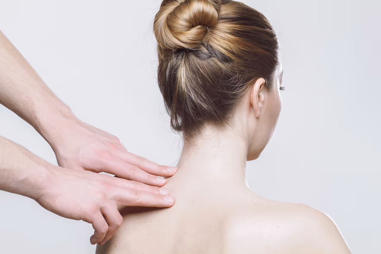 Woman receiving a professional shoulder massage therapy session, representing the importance of paying attention to persistent shoulder pain that may require medical evaluation for conditions like Pancoast tumors