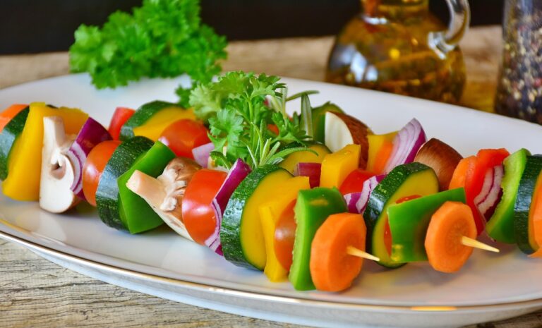 Colorful vegetable skewer with tomatoes, mushrooms, peppers and onions on a plate, representing healthy gut-friendly one-pot dinner ingredients