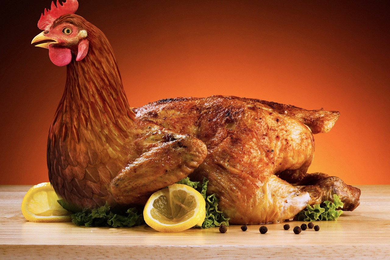 A beautifully roasted whole chicken on a serving platter, representing the main ingredient for Chicken Veronique, a classic French comfort dish with creamy sauce and roasted grapes.