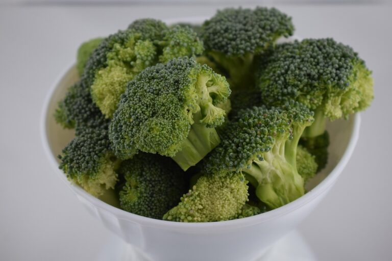 Fresh green broccoli florets arranged in a white bowl, perfect for healthy broccoli salad recipes with nutritious cruciferous vegetables