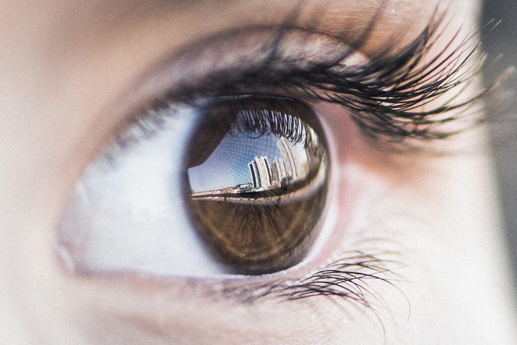 Close-up macro photograph of a human eye with a reflection, representing vision, eye health, and the new vitamin A discovery about cone cell development in the retina.