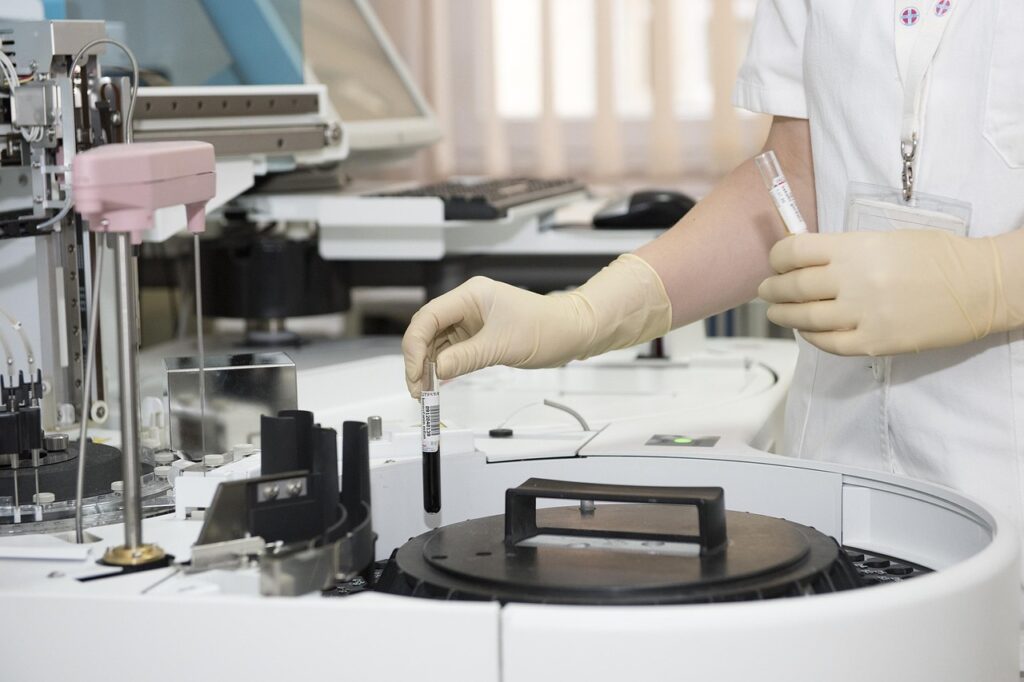 A medical professional in a white lab coat and blue gloves holds test tubes and vials in a laboratory setting, representing the scientific and medical applications of Botox beyond cosmetic use