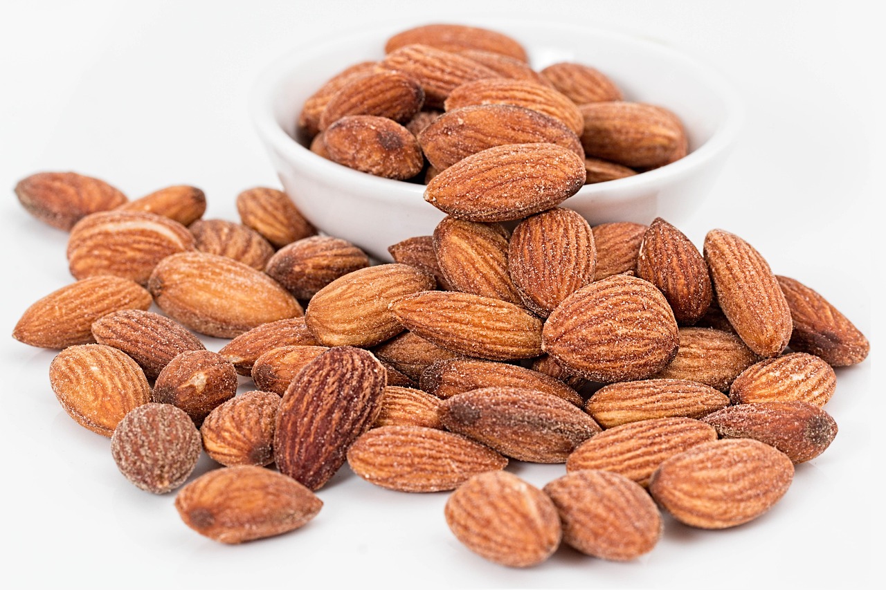 Roasted salted almonds in a bowl, a high-fiber snack that helps stabilize blood sugar levels