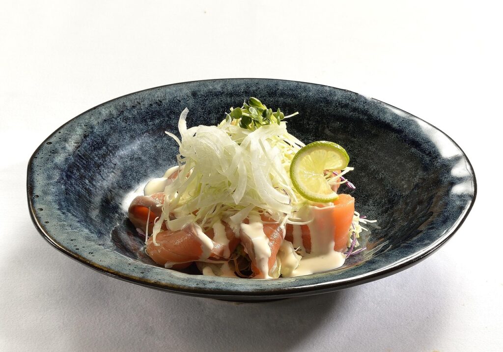 Fresh salmon salad with mixed vegetables on a plate, representing the Mediterranean diet's brain-healthy foods rich in omega-3 fatty acids, polyphenols, and antioxidants that help reduce cognitive decline risk in women.