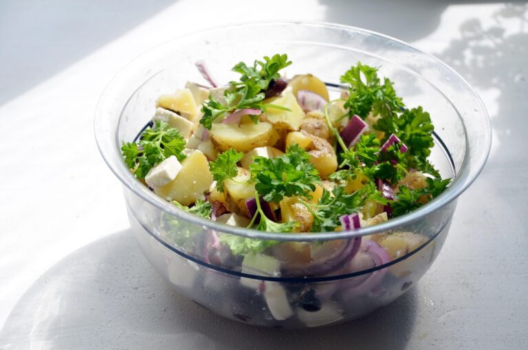 A bowl of creamy potato salad with fresh herbs, perfect for summer cookouts and blood sugar-friendly eating when prepared with smart ingredient choices and proper portions.