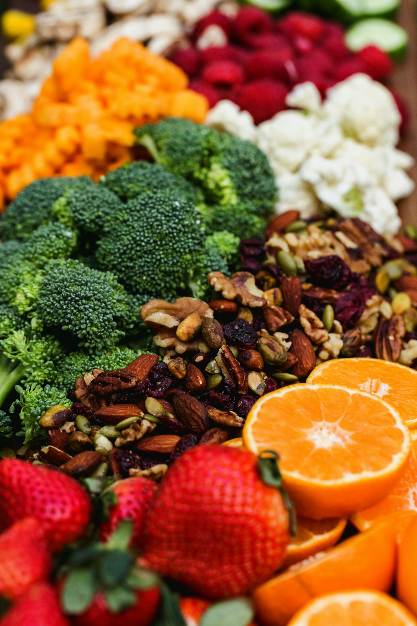 Sliced orange and fresh green broccoli on a wooden surface - two of the best vitamin C rich foods for supporting youthful skin health and collagen production