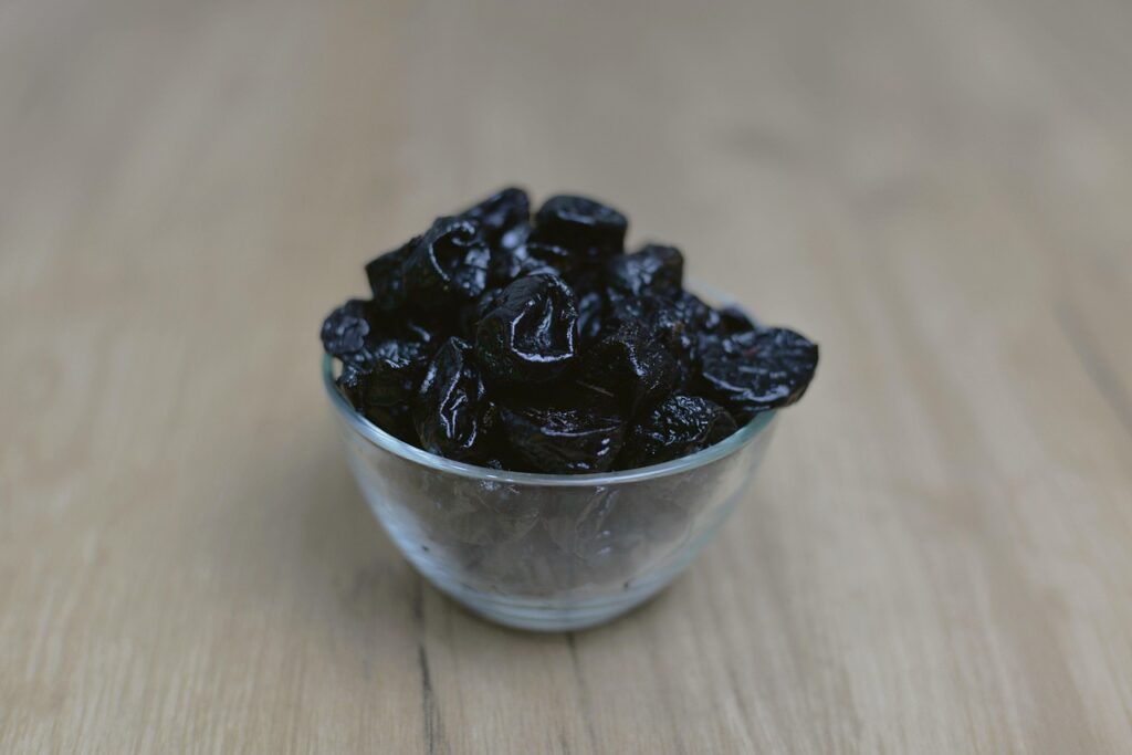 A bowl of prunes (dried plums), one of the best-studied natural foods for constipation relief, rich in fiber and sorbitol
