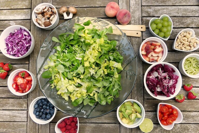 Colorful bowl of fresh whole foods including vegetables, legumes and fruit, illustrating a plant-forward, higher-carbohydrate, fiber-rich eating pattern associated with healthier biological aging and slower age-related physiological change
