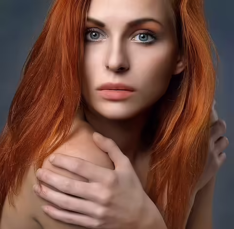 Young woman with beautiful long red hair, representing the beauty-from-within results of proper nutrition and key nutrients for healthy hair